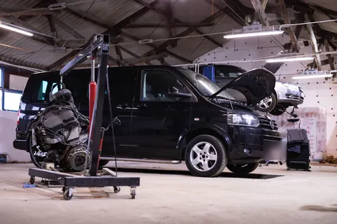 Motor scos, pe macara, lângă VW Transporter